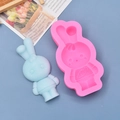 Macro shot of pink silicone bunny mold and blue carrot rabbit fondant figure - Single Rabbit