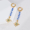Elegant gold drop earrings with blue crystal beads and sunburst charm on a white stand - Star Style (E866-mx)