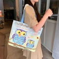 Off-white canvas tote bag featuring blue owl print and light blue shoulder straps - Owl