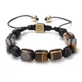 Handmade bracelet with brown tiger eye stones and black lava beads on white background - Tiger's Eye