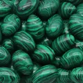 Polished egg-shaped natural malachite semi-precious stone with green banded patterns - Malachite (Synthetic) (1pc)