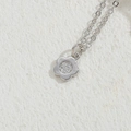 Silver flower pendant necklace with pavé cubic zirconia on a rustic stone background - Smooth Flower Style (XL2433) / Silver