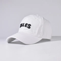 Close-up of black TALES 3D embroidery on a white cotton baseball cap with seam details - White
