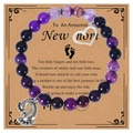 Detail of pink zebra stone bracelet with baby feet charm and heart on a greeting card - Purple Agate