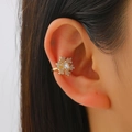 Close-up of gold snowflake ear cuff with zircon inlay on model's ear cartilage - Snowflake Style (G-101) / Gold