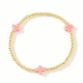 Bracciale di perle dorate con tre ciondoli a croce rosa pallido su sfondo bianco pulito - Croce Rosa-Perline Oro