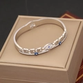 Detailed macro of silver wave bangle featuring blue evil eye charms and white zircon - Wavy Hollow Triple Eye Style (6#)