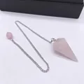 Macro shot of rose quartz pendulum with silver chain on white background - Rose Quartz
