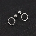 Detail of silver twisted rope hoop earrings with secure screw-back ball closures - Twisted Round / Steel