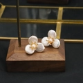 Elegant flower-shaped earrings with white baroque pearls and peach center in gold setting - Three Petal Flower Style