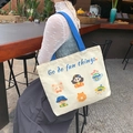 Off-white canvas tote bag with blue handles and 'Go do fun things' cartoon print - Cute Life