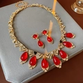Macro detail of vintage gold jewelry set with red teardrop stones and crystals - 97# Necklace Earrings Set Rhinestone Resin Bow Teardrop (2pcs/Set)