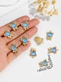 Detail shot of golden bow pendant with blue gem including dimensions 1.3cm by 1.8cm - Sky Blue