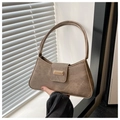 Detailed shot of brown suede underarm bag featuring a gold rectangular metal buckle - Coffee