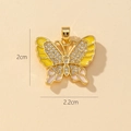 Detail view of a 2cm gold butterfly pendant with colorful enamel and inlaid crystals - E-Enamel Butterfly (2x2.2cm)