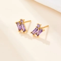 Macro shot of gold S925 silver stud earrings with rectangular purple zircon stones - Gold-Purple Zirconia