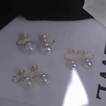 Macro detail of iridescent pearl earrings featuring silver adjustable screw clips - Clip-on-8mm