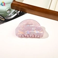 Close-up of pink cloud-shaped resin hair claw clip with pearlescent finish texture - PVC 8cm Round Head - Iridescent Purple