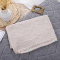 Detail of soft muslin baby blanket with delicate white lace trim and breathable cotton texture - Khaki