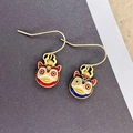 2401131 Asymmetric Lion Dance Earrings