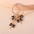Golden keychain with three black enamel dragonflies and a tiny floral pendant - Black