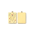 Macro view of 14K gold Aries pendant with colorful crystals and stylized ram pattern - Capricorn