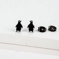 Minimalist matte black penguin stud earrings on white stone display stand - Penguin / Black