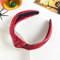 Close-up of red spider web headband with top knot detail and Halloween festive decorations - Halloween Knot Headband - Red Spider Web