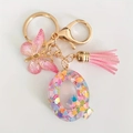 Letter Q keychain with pink resin sequins, hollow butterfly pendant, and pink tassel - Letter Q