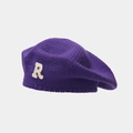 Close-up of a purple knitted beret showing white towel embroidery R letter and fabric texture - Purple
