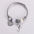 Detail of silver beaded bracelet featuring heart charm, key pendant and shell pearl accents - Pearl White Beaded (Style 2)