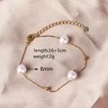 Detail of gold titanium bracelet with pearls and lobster clasp on silk background - Round Pearl Bracelet (8mm)