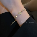 Gold plated four-leaf clover bracelet with cat eye stone and sparkling zircons - Rhinestone Clover Cat Eye