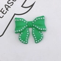 Detail of green resin bow charm with white pearl embellishments for DIY phone cases - Dark Green