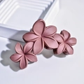 Matte pink frangipani flower hair claw clip with triple blossom design on white steps - Three-Flower Claw Clip / Brick Red