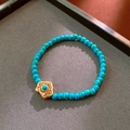 Retro turquoise beaded bracelet with gold plated filigree pendant on grey tray - 34# Bracelet-Gold-Blue (Turquoise Filigree Pendant)