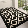 Felpudo geométrico minimalista en negro y beige con material absorbente y antideslizante - 50x80cm / Diseño Parker