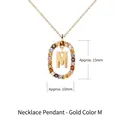 Gold letter M pendant necklace with colorful crystals and an oval frame design - Gold Letter M