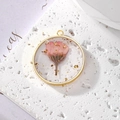 Macro shot of circular resin pendant with pink dried flower and gold foil flakes - September Pink Chrysanthemum With Gold Foil