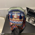 Ethnic bohemian bucket bag with colorful woven patterns, tassels, and a wide shoulder strap - Green