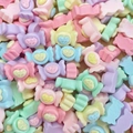 Macro shot of colorful pastel resin candy charms with embossed candy text for DIY crafts - Candy Heart with Text