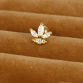 Détail macro d'une boucle d'oreille trèfle dorée avec zircons sur présentoir en velours - Couronne de Trèfle / Or / 0,1