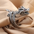 Vintage silver dragon ring with red gem eyes and intricate scale textures on brown fabric - Dragon Ring / Antique Silver