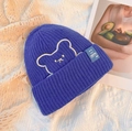 Winter knit beanie in cobalt blue featuring white bear embroidery and a smiley face patch - One Size / Blue