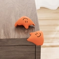 Paraspigoli in silicone arancione a forma di fantasma per angoli di tavoli in legno - Angolo Fluido Arancione