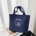 Detail of dark blue corduroy tote bag featuring a cute cartoon bear drinking milk tea - Sheep Milk Tea Blue