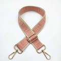 Detail of adjustable woven strap with pink geometric pattern and gold swivel hooks - Pink