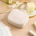 Beige PU square sanitary napkin storage bag with golden Sunny Girl text and strap - White