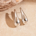 Polished silver teardrop earrings with a minimalist sleek design on a stone surface - Stainless Steel Pin - Silver Teardrop