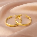 Chic polished golden hoop earrings displayed on premium elegant champagne silk fabric - E066 Gold 40mm